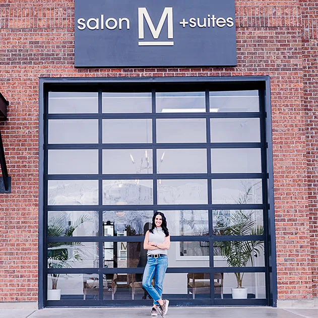 Lady posing outside Salon M + Suites