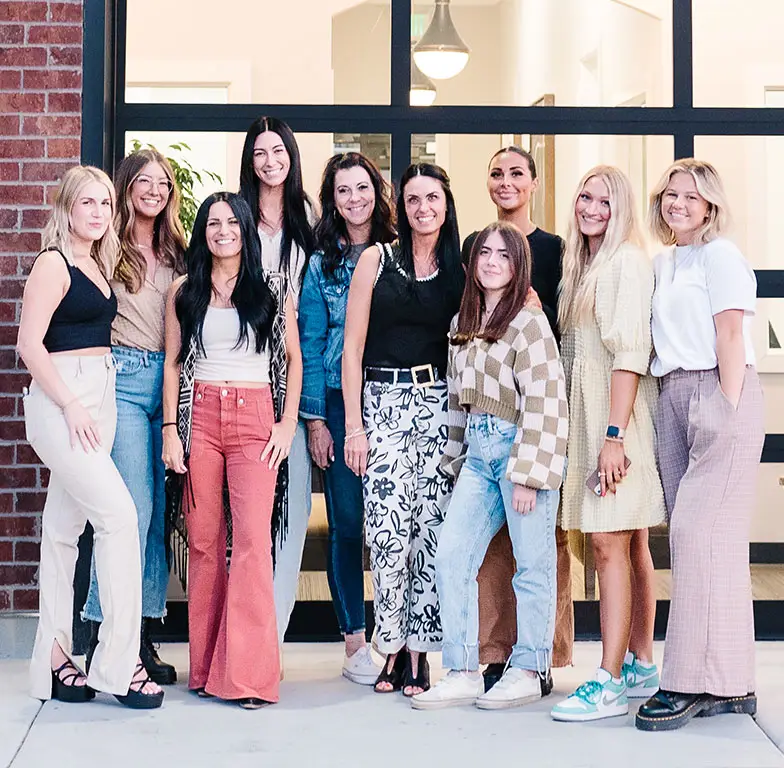 The team at the American Fork office of Salon M + Suites working together in a professional environment.